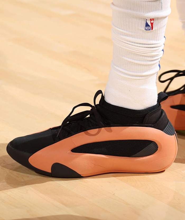 Los Angeles Clippers guard James Harden's black and orange adidas sneakers.